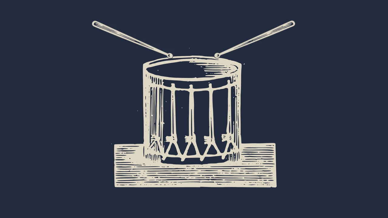 An engraved drum and drumsticks
